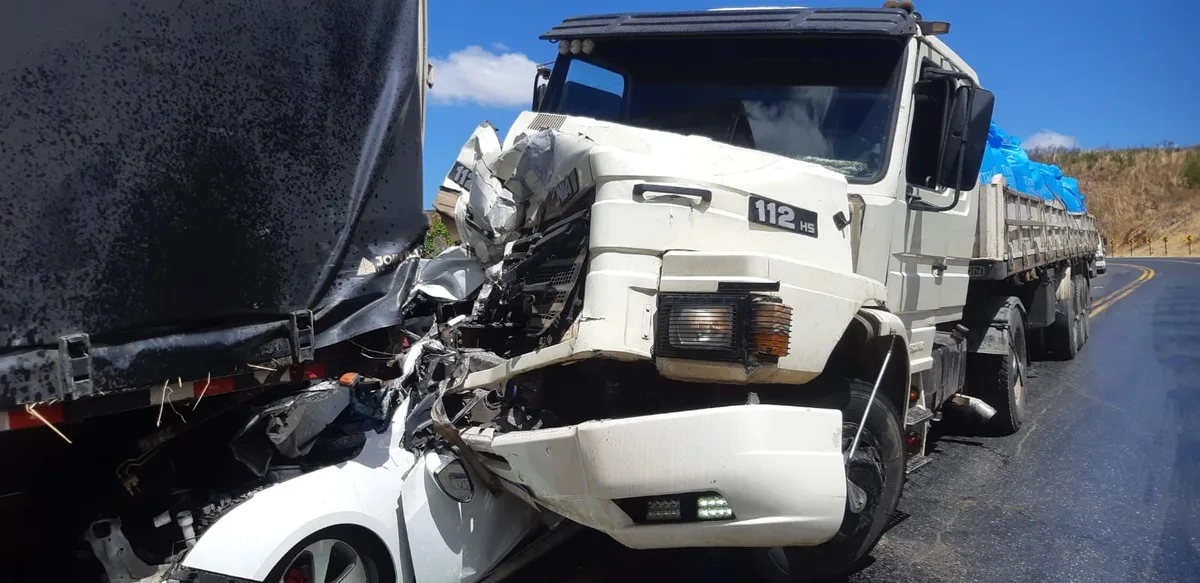 Carro fica prensado entre carreta e caminhão, e quatro ocupantes sobrevivem